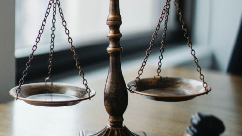 A legal justic scale on desk - Criminal Defense Lawyer concept image
