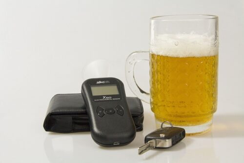 beer, car keys, and breathalyzer device