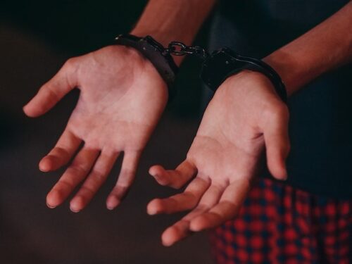 handcuffed man palms facing up