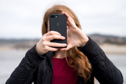 woman holding phone in front of her face