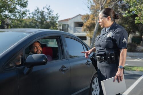 police officer talking to man in car