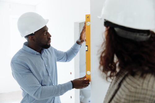 man using ruler to measure wall