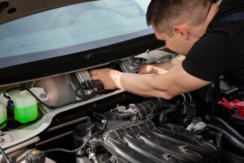 person working on car engine