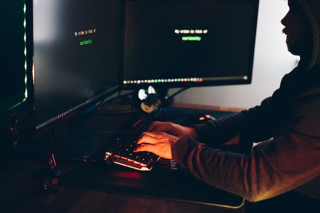 man in dark room on computers