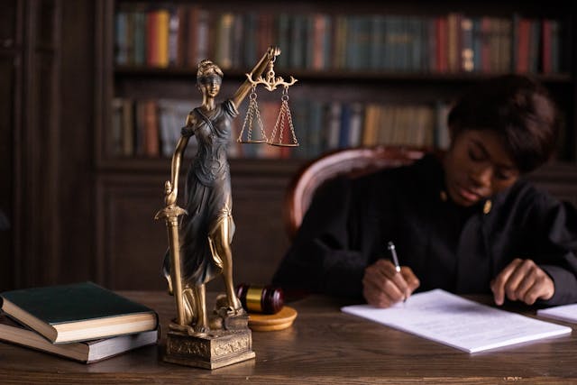 judge writing next to statute of justice.