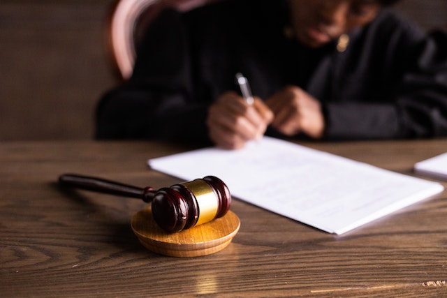judge writing on paper
