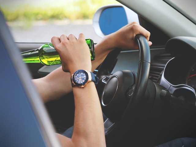 person drinking while driving