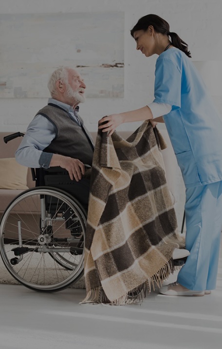 elderly man in wheelchair with a nurse