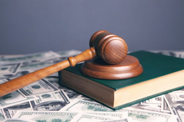 gavel atop book with money